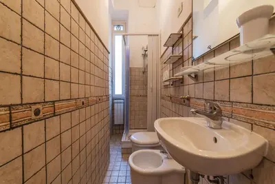 a bathroom with two toilets and a sink at GuestHost - Borgo Pio Elegant Apartment! in Rome