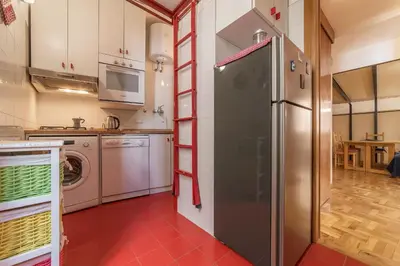 a kitchen with a refrigerator and a washing machine at GuestHost - Lovely Loft Trastevere in Rome