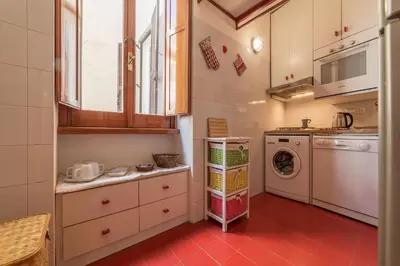 a small kitchen with a washing machine and a washer at GuestHost - Lovely Loft Trastevere in Rome