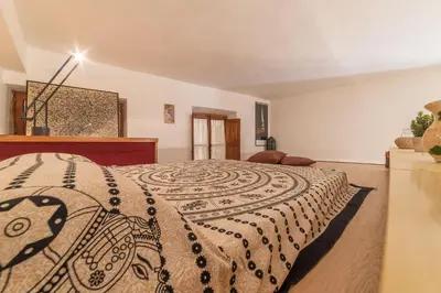 a bedroom with a bed with a blanket on it at GuestHost - Lovely Loft Trastevere in Rome