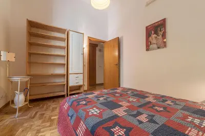 a bedroom with a bed and a dresser in it at GuestHost - Lovely Loft Trastevere in Rome