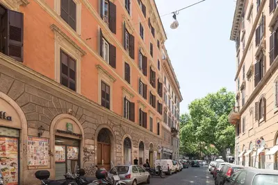a city street with cars parked on the side of buildings at GuestHost - Lovely Loft Trastevere in Rome
