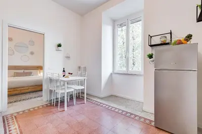 a kitchen with a table and a refrigerator at BDC - Termini Sun Apartment in Rome