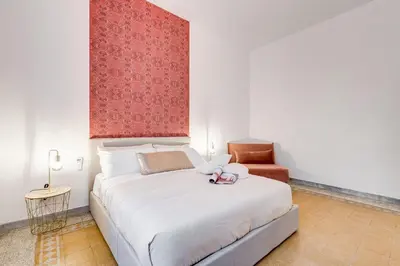 a bedroom with a large white bed and a chair at BDC - Termini Sun Apartment in Rome