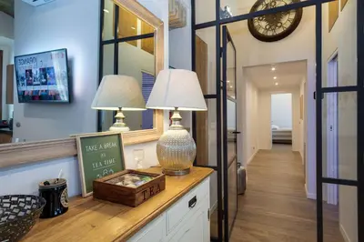 a hallway with two lamps on a dresser in a house at One & Only Buonarroti Suite in Rome