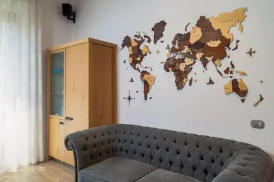 a couch in a room with a map of the world on the wall at One & Only Buonarroti Suite in Rome