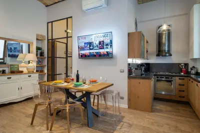 a kitchen with a table and chairs in a room at One & Only Buonarroti Suite in Rome