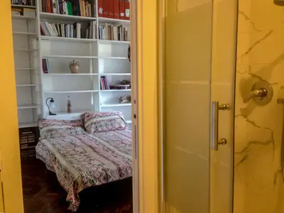 a room with a bed and a book shelf with books at LUMINOSA VISTA PIRAMIDE in Rome