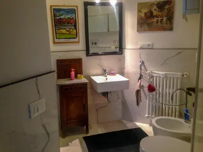a bathroom with a sink and a toilet and a mirror at LUMINOSA VISTA PIRAMIDE in Rome