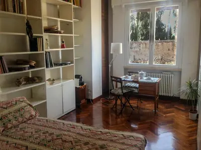 a living room with a couch and a table and a window at LUMINOSA VISTA PIRAMIDE in Rome