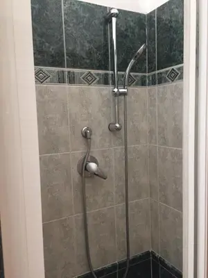 a shower with a hose in a bathroom at Appartamento vicino Stazione Termini e Colosseo in Rome