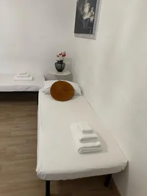 a room with two beds with towels on a bench at Appartamento vicino Stazione Termini e Colosseo in Rome