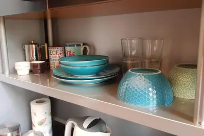 a shelf with plates and bowls and cups on it at A casa di Juno 
