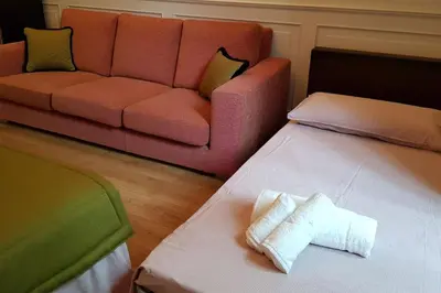 a living room with a couch and two beds at A casa di Juno 