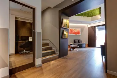 a hallway with a living room and a stairway at Rome Art Hotel - Gruppo Trevi Hotels in Rome