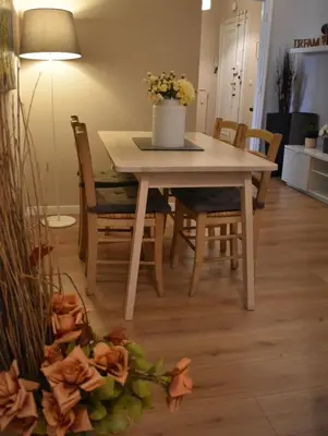 a dining room table and chairs with flowers on the floor at Domus Claudia in Rome