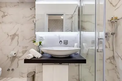a white bathroom with a sink and a shower at Trevi Private Suites by Premium Suites Collection in Rome