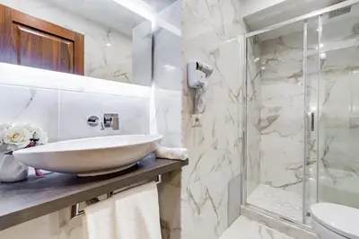 a bathroom with a sink and a shower at Trevi Private Suites by Premium Suites Collection in Rome