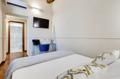 a hotel room with two beds and a table at Trevi Private Suites by Premium Suites Collection in Rome