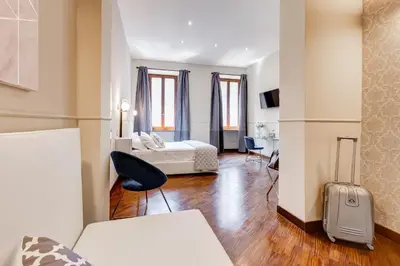 a hotel room with a bed and a suitcase at Trevi Private Suites by Premium Suites Collection in Rome