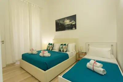 two beds in a bedroom with blue and white at San Peter Dill House in Rome