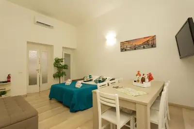 a living room with a table and a dining room at San Peter Dill House in Rome