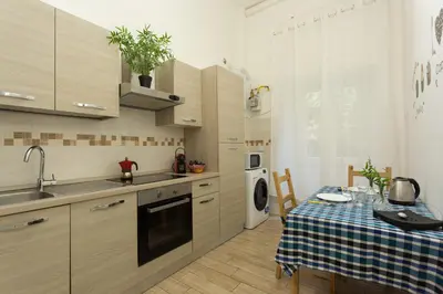 a kitchen with a table and a sink and a stove at San Peter Dill House in Rome
