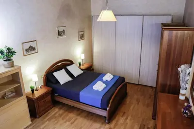 a bedroom with a bed with blue sheets and white pillows at Domus Titiana Amazing Apartment in Trastevere in Rome