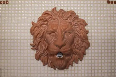 a carving of a lion on a wall at Domus Titiana Amazing Apartment in Trastevere in Rome