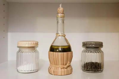 a bottle of wine with a whisk next to two glass jars at Domus Titiana Amazing Apartment in Trastevere in Rome