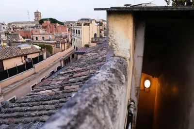 a view of a city from the roof of a building at Domus Titiana Amazing Apartment in Trastevere in Rome