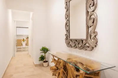 a dining room with a glass table and a mirror at Divo Apartments - Spanish Steps in Rome