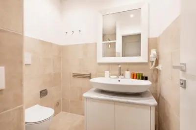 a bathroom with a sink and a toilet at Divo Apartments - Spanish Steps in Rome