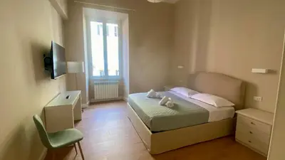 a bedroom with a bed with two stuffed animals on it at SWEET DREAM CAVOUR in Rome