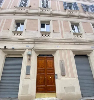 a building with two garage doors and a large wooden door at SWEET DREAM CAVOUR in Rome