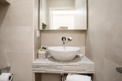 a bathroom with a sink and a mirror at SWEET DREAM CAVOUR in Rome