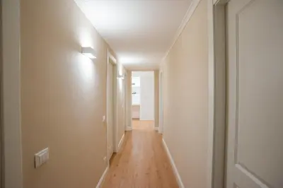 an empty hallway with a white ceiling and a wooden floor at SWEET DREAM CAVOUR in Rome