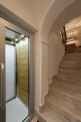a staircase with a glass door leading up to a building at Laurina 33 in Rome