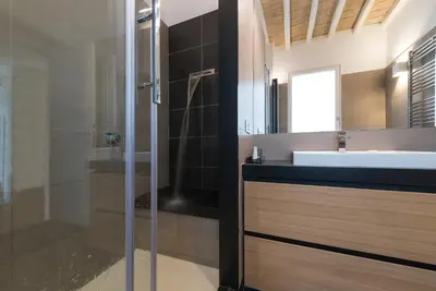 a bathroom with a glass shower and a sink at Laurina 33 in Rome