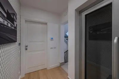 a hallway with a white door and a wall at Laurina 33 in Rome