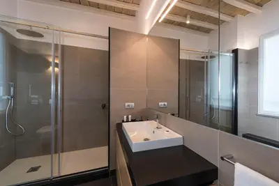 a bathroom with a sink and a glass shower at Laurina 33 in Rome
