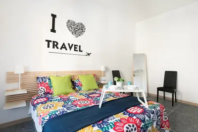 a bedroom with a bed and a table at Stars Luxury Apartments 1 in Rome