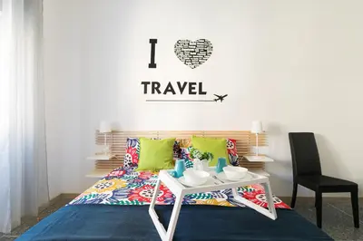 a bedroom with a bed and a table with a table sidx sidx sidx at Stars Luxury Apartments 1 in Rome
