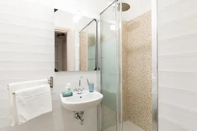 a bathroom with a sink and a shower at Stars Luxury Apartments 1 in Rome