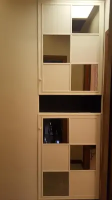 a white cabinet with glass doors in a room at Uso Turistico vicino San Giovanni in Rome