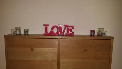 a wooden dresser with a love sign on top of it at Uso Turistico vicino San Giovanni in Rome
