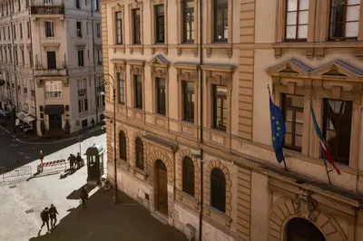 a building with a flag on the side of it at Sidus Suite in Rome