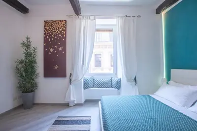 a bedroom with a bed with a green wall at Sidus Suite in Rome