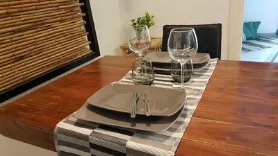 a table with two plates and wine glasses on it at Sidus Suite in Rome