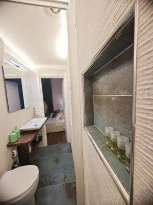 a window with green curtains in a bedroom at Sidus Suite in Rome